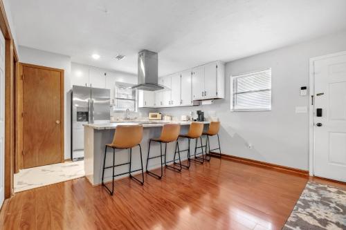 a kitchen with a counter and bar stools at A Touch of Serenity in Tallahassee