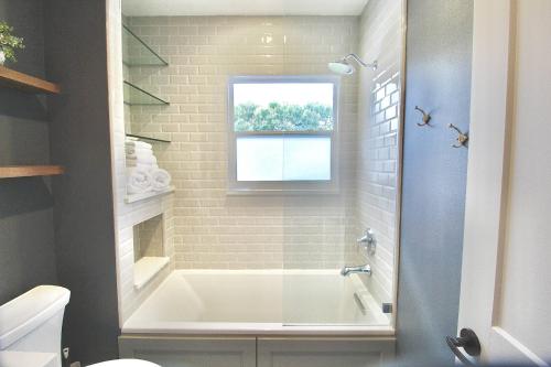a white bath tub in a bathroom with a window at Pelicans Landing in Stuart