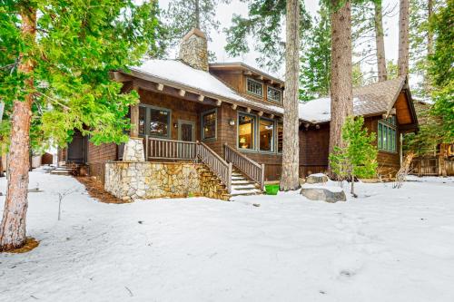 a house in the woods with snow on the ground at Lakefront Luxury in Tahoe City