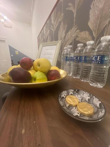 two plates of fruit on a table with bottles of water at piccolo Hotel in Glasgow