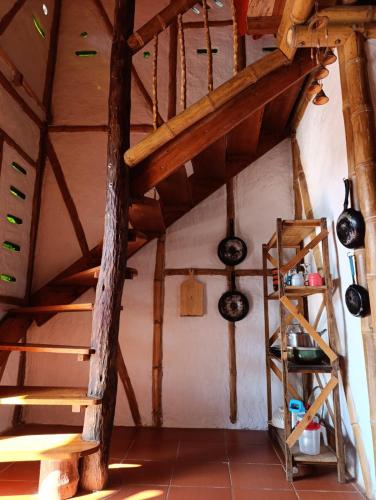 an attic room with wooden stairs and wine bottles at Casa Entera Finca Cometa in San Agustín