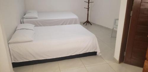 a bedroom with two beds in a room at Nosso Quintal Naturista Liberal in Conde