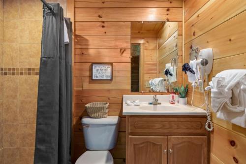 a bathroom with a toilet and a sink at Heavenly Bliss By Ghosal Luxury Lodging in Sevierville