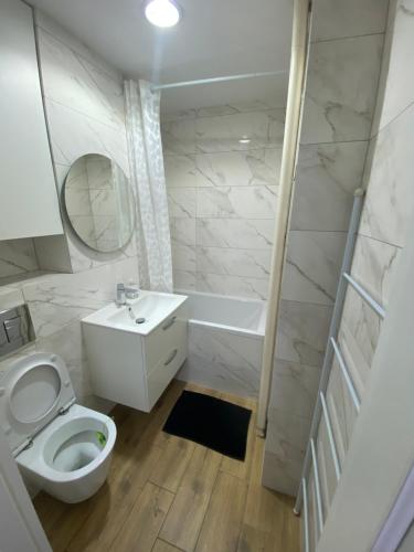 a bathroom with a toilet and a sink and a tub at Rooms in Warsaw - G39 in Warsaw