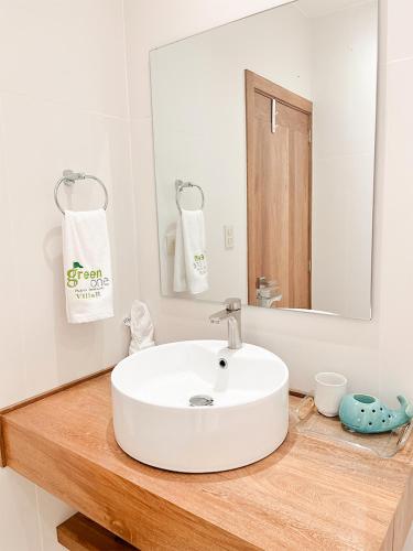 a bathroom with a white sink and a mirror at Xeliter Green One Playa Dorada in San Felipe de Puerto Plata