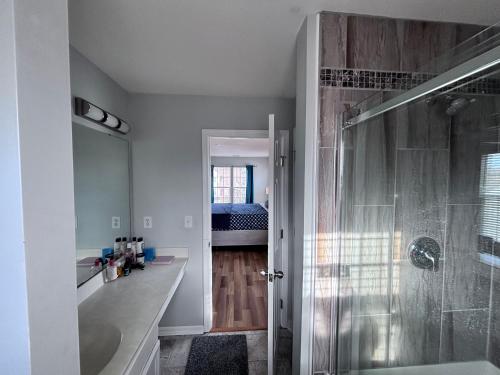 a bathroom with a shower and a sink and a tub at Amazing 4 BDRM home w garage in Charlotte in Charlotte