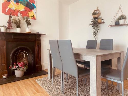 a dining room table with chairs and a fireplace at Iconic Location 3 Bed 2 Bath Flat near Regents Park in London