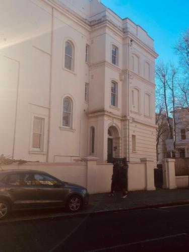 a car parked in front of a white building at Iconic Location 3 Bed 2 Bath Flat near Regents Park in London