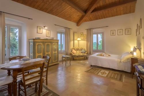 スペッロにあるAgriturismo Cuore Verde Alloroのベッドとテーブルと椅子のある寝室