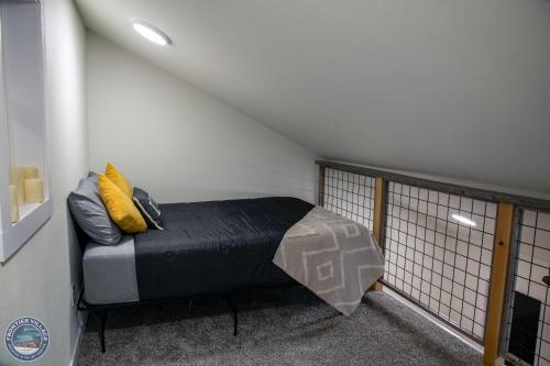 a small room with a bed in a attic at The Wandering Wolf - Frontier Village in North Pole