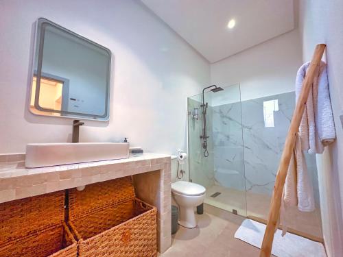 a bathroom with a sink and a glass shower at Villa soléa - Route Ouarzazate in Marrakesh