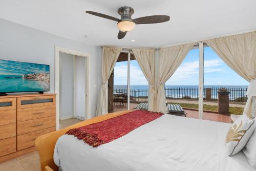 a bedroom with a bed and a television and a balcony at Sea Forever - DMST3536 in Solana Beach