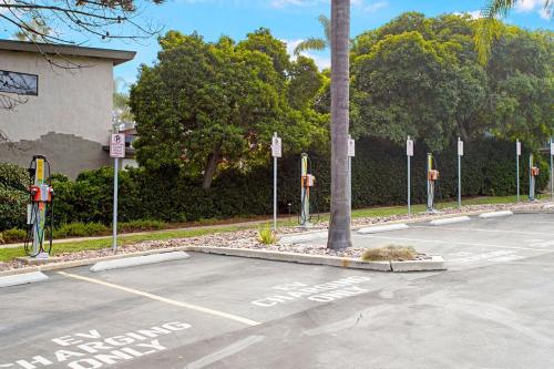 a parking lot with parking meters and a palm tree at Relax & Renew - SONG8 in Solana Beach