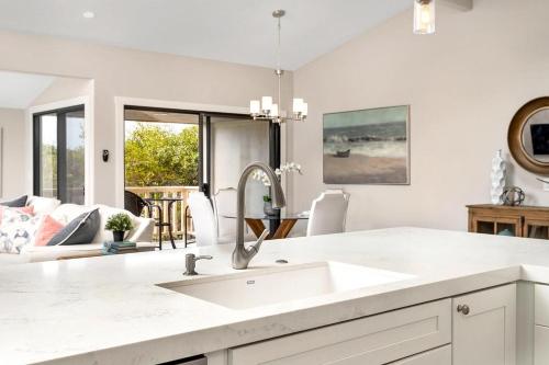 a kitchen with a sink and a living room at Endless Summer - SUR149 in Solana Beach