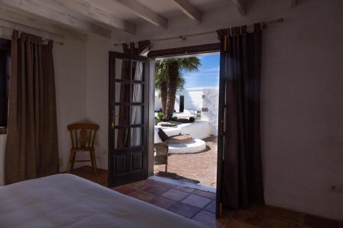 a bedroom with a door open to a patio at Casa Margarita Soo in Soo