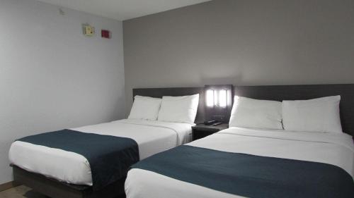 a hotel room with two beds in a room at Motel 6-West Des Moines, IA in West Des Moines