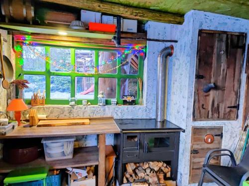 a kitchen with a wooden table and a window at Chalupa u Žofky in Oščadnica
