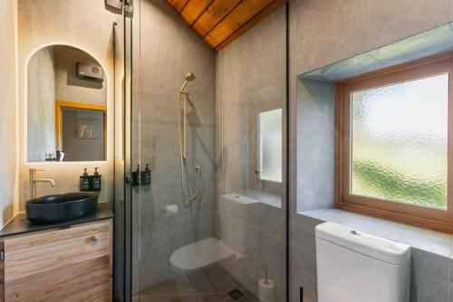 a bathroom with a shower and a sink at St Patrick's Church - Hawea Flat in Hawea Flat