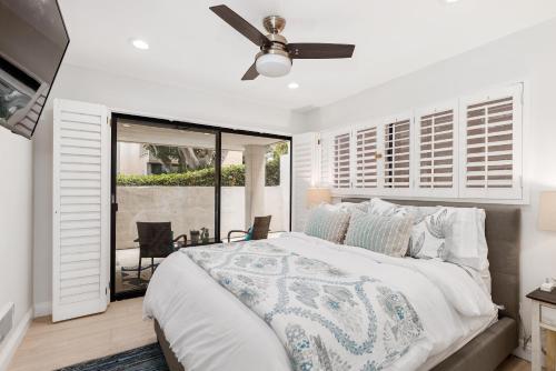 a bedroom with a bed and a ceiling fan at Solana Escape - SUR44 in Solana Beach