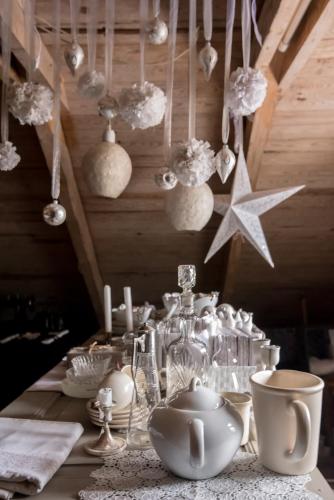 a table with white dishes and other items on it at Vita Krala in Haddebo