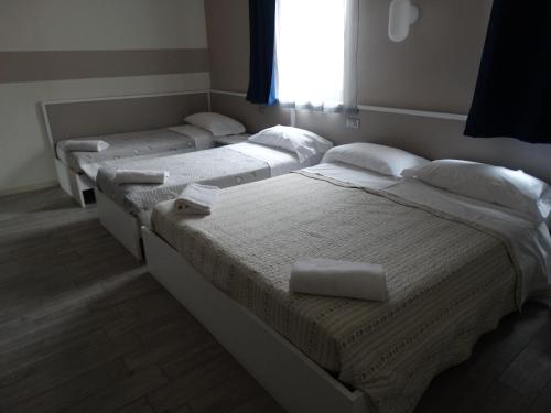 Postel nebo postele na pokoji v ubytování Hotel Moderno