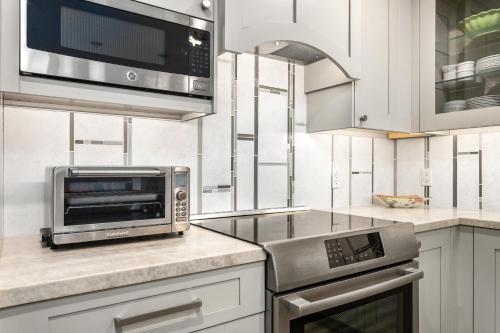 a kitchen with a toaster oven and a microwave at Sea Gem - SBTC119 in Solana Beach
