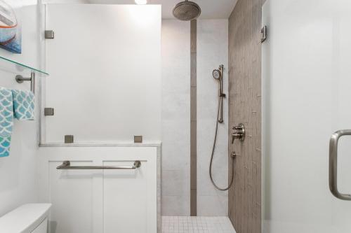 a bathroom with a shower with a glass door at Sea Gem - SBTC119 in Solana Beach