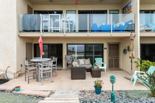 a house with a balcony with chairs and a table at Sea Gem - SBTC119 in Solana Beach