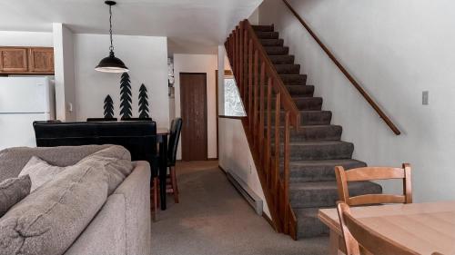 a living room with a staircase with a piano at Crystal Run in Sandpoint