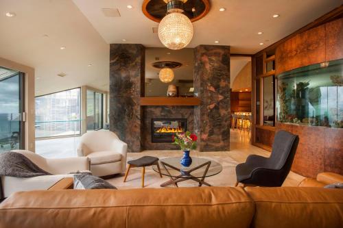 a living room with a couch and a fireplace at Enchanting Oasis - SONG72 in Solana Beach
