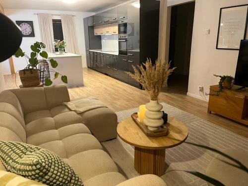 a living room with a couch and a table at Jenny's Guest House in Kristianstad