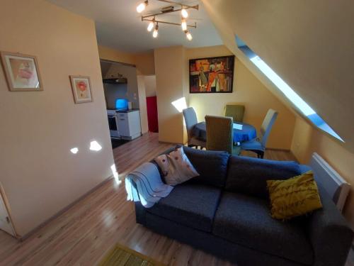 a living room with a couch and a table at Gîte meublé 10 personnes in Donges