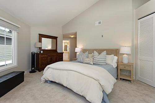 a bedroom with a large bed and a mirror at Trackside Tides - DM2925 in San Diego
