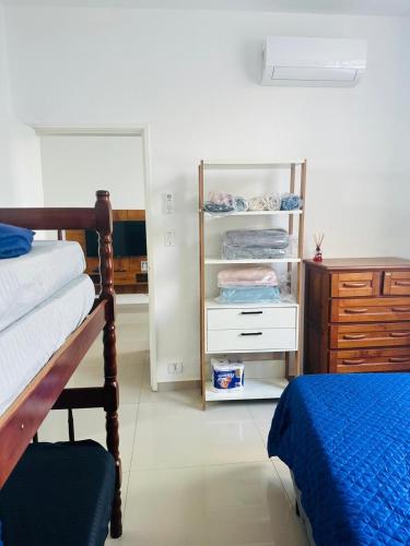 une chambre avec un lit et une commode dans l'établissement Apartamento em Guarujá Centro, à Guarujá