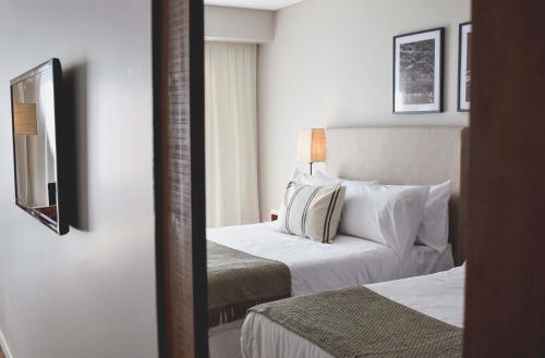 Cyan Soho Neuquén Hotelにあるベッド