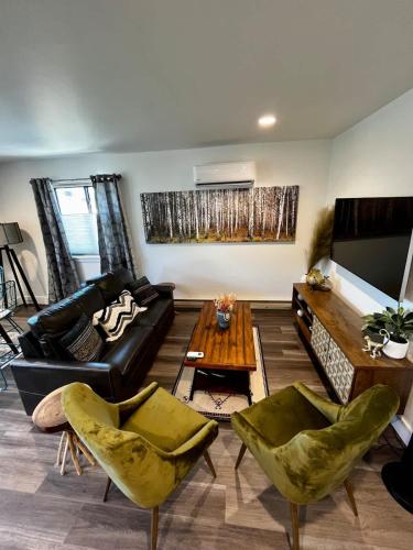 a living room with a couch and a flat screen tv at Brand New Loft in the Heart of Downtown Bozeman in Bozeman