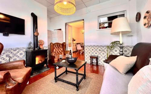 a living room with a couch and a fireplace at Romans House in Évora