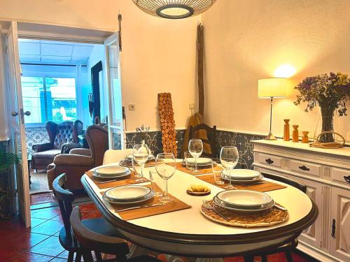 a dining room table with wine glasses on it at Romans House in Évora
