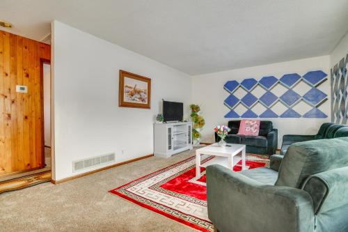 a living room with a couch and a tv at 2 Mi to Dtwn St Paul Home with Private Deck and Yard! in Saint Paul