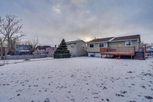 a house with a yard with snow on the ground at 2 Mi to Dtwn St Paul Home with Private Deck and Yard! in Saint Paul