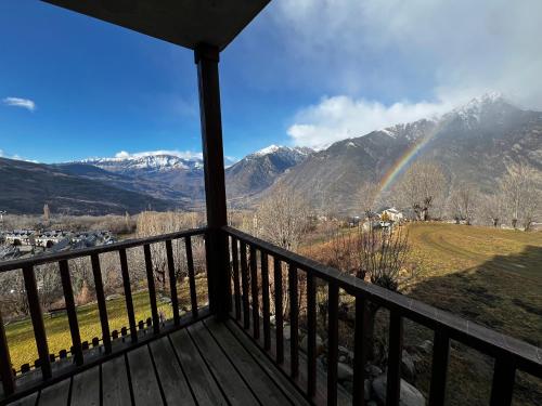 a view from a deck with a rainbow at Julia Petulia en Cerler in Cerler