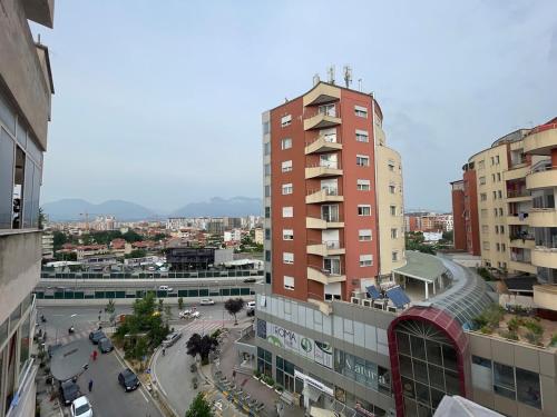 a view of a city with a tall building at Gold Apartment Tirana in Tirana