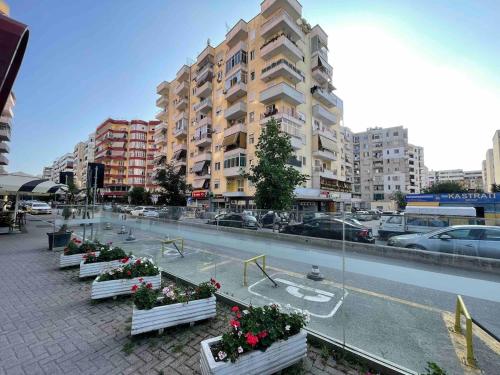 a row of benches in front of a building at Gold Apartment Tirana in Tirana
