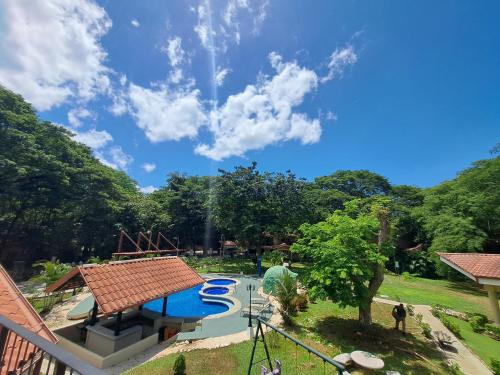 a view of a swimming pool in a park at Papagayo Hotel y Villas in Playa Panama