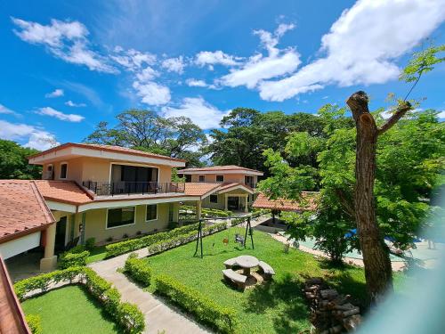 a view of the garden of a house with a statue at Papagayo Hotel y Villas in Playa Panama