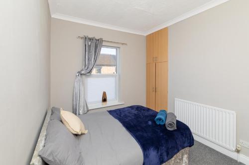 a bedroom with a bed and a window at Hampton House in Stockton-on-Tees