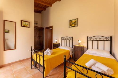 a bedroom with two beds in a room at Tenuta Santicuti in Acaya