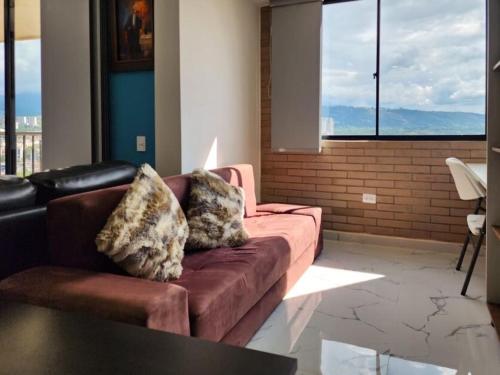 a living room with a couch with two pillows on it at 1909 Luxury Cerca Clínica Foscal & Ardila Lulle in Floridablanca