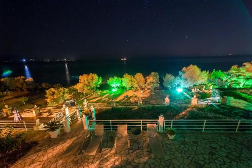 a view of a park at night with green lights at Laura Beach House in Alykes