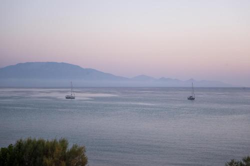 two boats in a large body of water at Laura Beach House in Alykes